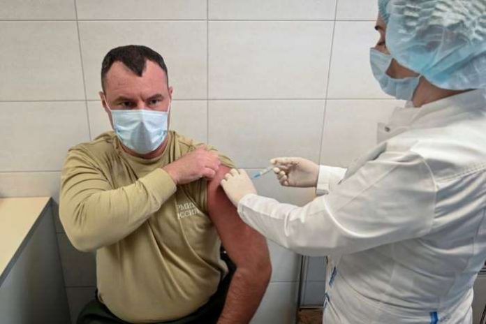 A Russian Army service member receives an injection of the Sputnik V vaccine against COVID-19 at a clinic in the city of Rostov-On-Don, Russia [Sergey Pivovarov-Reuters]