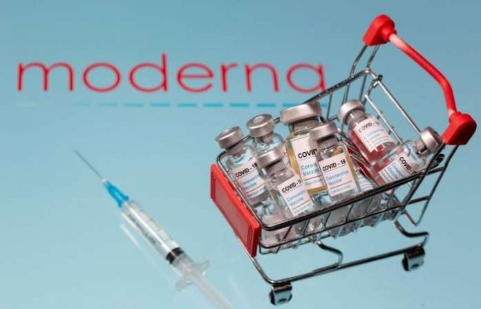 A small shopping basket filled with vials labelled COVID-19 - Coronavirus Vaccine and a medical syringe are placed on a Moderna logo in this illustration taken November 29, 2020. Picture taken November 29, 2020. REUTERS-Dado Ruvic-File Photo