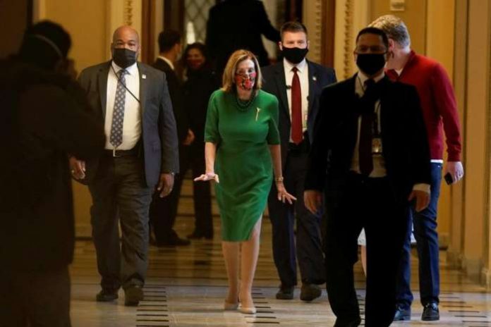 Speaker of the House Nancy Pelosi (D-CA) walks back to her office after opening the House floor following an agreement of a coronavirus disease (COVID-19) aid package the night before on Capitol Hill, Washington, D.C., U.S., December 21, 2020. REUTERS Speaker of the House Nancy Pelosi (D-CA) walks back to her office after opening the House floor following an agreement of a coronavirus disease (COVID-19) aid package the night before on Capitol Hill, Washington, D.C., U.S., December 21, 2020. REUTERS