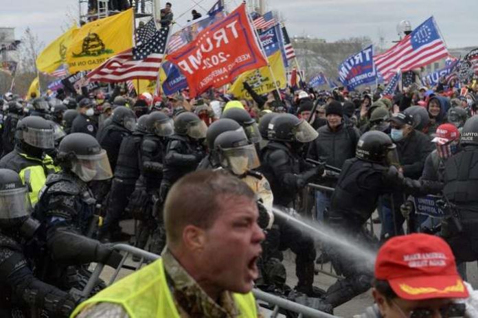 Trump supporters clash with police and security forces as people try to storm the Capital Building in Washington. [Joseph Prezioso-AFP] (AFP)