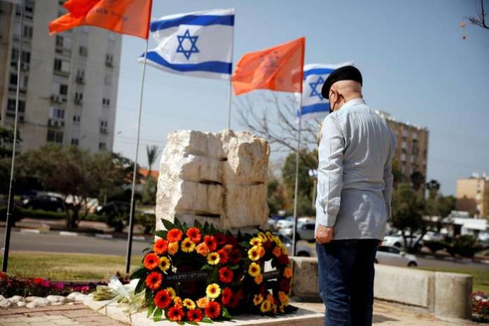A man stands still as a two-minute siren marking the annual Israeli Holocaust Remembrance Day is heard in Ashkelon, Israel April 8, 2021. REUTERS-Amir Cohen A man stands still as a two-minute siren marking the annual Israeli Holocaust Remembrance Day is heard in Ashkelon, Israel April 8, 2021. REUTERS-Amir Cohen