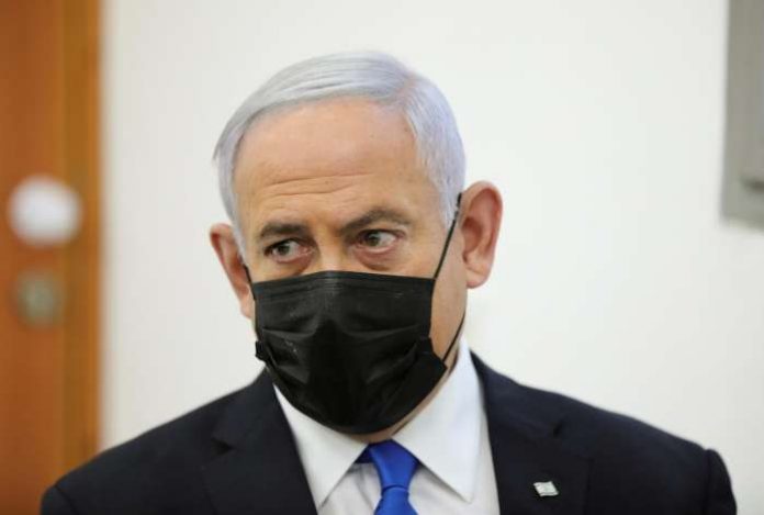 Israeli Prime Minister Benjamin Netanyahu, wearing a face mask, looks as his corruption trial resumes, at Jerusalem's District Court April 5, 2021. Abir Sultan-Pool via REUTERS Israeli Prime Minister Benjamin Netanyahu, wearing a face mask, looks as his corruption trial resumes, at Jerusalem's District Court April 5, 2021. Abir Sultan-Pool via REUTERS