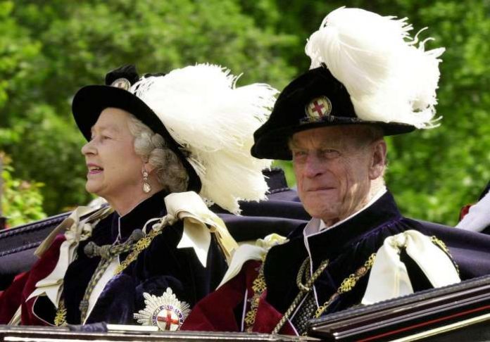 FILE PHOTO: Britain's Queen Elizabeth II and Prince Phillip, the Duke of Edinburgh, wearing their Order of the Garter robes, ride in an open-topped carriage to Windsor Castle following the Garter Ceremony, June 18, 2001. REUTERS/File Photo FILE PHOTO: Britain's Queen Elizabeth II and Prince Phillip, the Duke of Edinburgh, wearing their Order of the Garter robes, ride in an open-topped carriage to Windsor Castle following the Garter Ceremony, June 18, 2001. REUTERS/File Photo