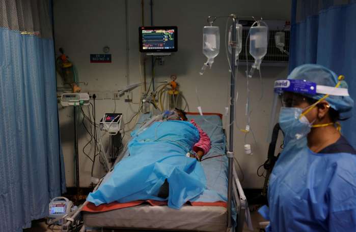 A man suffering from coronavirus disease (COVID-19) receives treatment as a Syringe Infusion Pump, donated by France is seen next to his bed, inside the emergency room of Safdarjung Hospital in New Delhi, India, May 7, 2021. REUTERS-Adnan Abidi