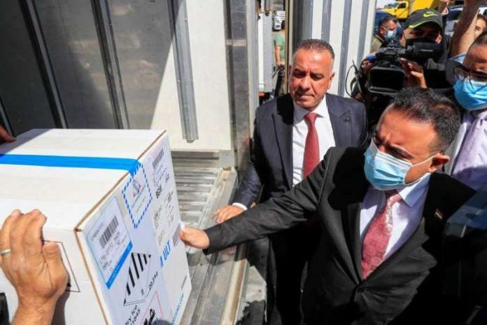 FILE PHOTO: Health Minister Hassan al-Tamimi checks the first shipment of the Pfizer's vaccine against the coronavirus disease (COVID-19) at Baghdad International Airport, in Baghdad, Iraq April 11, 2021. REUTERS/Thaier Al-Sudani FILE PHOTO: Health Minister Hassan al-Tamimi checks the first shipment of the Pfizer's vaccine against the coronavirus disease (COVID-19) at Baghdad International Airport, in Baghdad, Iraq April 11, 2021. REUTERS/Thaier Al-Sudani