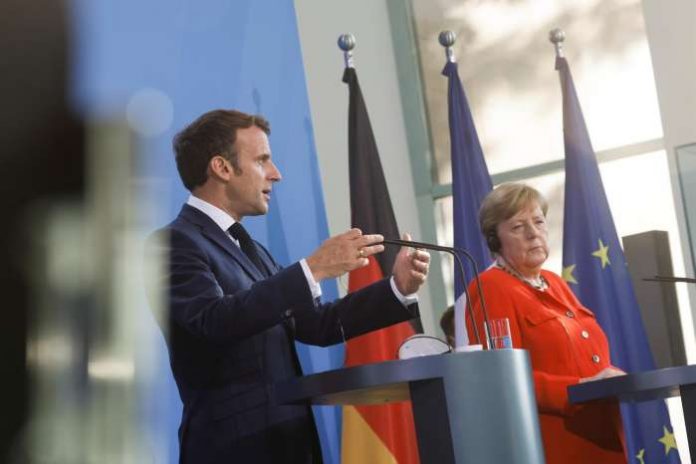 French President Emmanuel Macron speaks as he and German Chancellor Angela Merkel give a news statement in Berlin, Germany, June 18, 2021. REUTERS-Axel Schmidt-Pool French President Emmanuel Macron speaks as he and German Chancellor Angela Merkel give a news statement in Berlin, Germany, June 18, 2021. REUTERS-Axel Schmidt-Pool