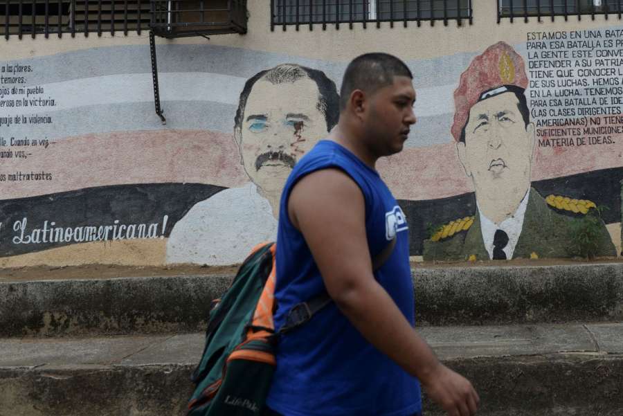 A man walks past a mural showing Nicaraguan President Daniel Ortega and late Venezuelan President Hugo Chavez in Managua, Nicaragua June 30, 2021. REUTERS-Stringer