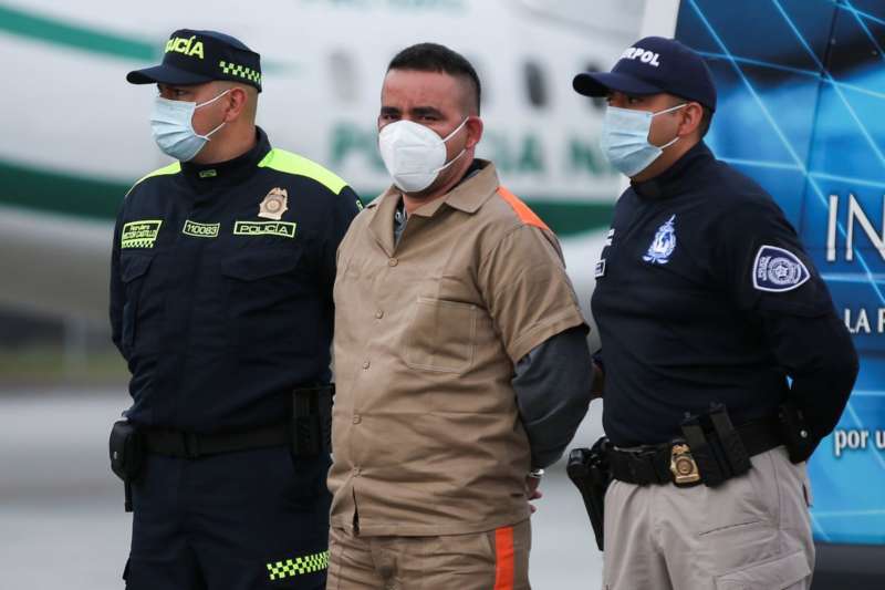 Yamit Picon Rodriguez, an alleged member of the National Liberation Army (ELN), is escorted by the police, before being extradited to the U.S., where he is accused of drug trafficking crimes, at an airport in an anti-narcotics base in Bogota, Colombia, August 19, 2021. REUTERS/Luisa Gonzalez
