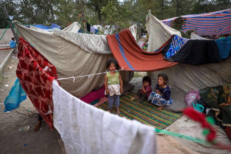 Internally displaced families from northern provinces, who fled from their homes due to the fighting between Taliban and Afghan security forces, take shelter in a public park in Kabul, Afghanistan, 14 August (issued 15 August). The Taliban captured Mazar-i-Sharif, the country's fourth-largest city and the government's last major stronghold in the north on 14 August, as they tightened their grip on the country and closed in on Kabul. Most of the remote districts of the provinces have already fallen to the Taliban in the past three months. EPA-EFE/HEDAYATULLAH AMID