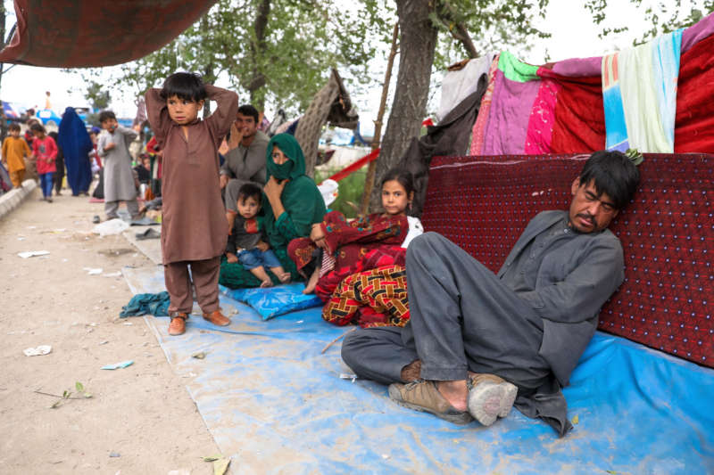 Internally displaced families from northern provinces, who fled from their homes due to the fighting between Taliban and Afghan security forces, take shelter in a public park in Kabul, Afghanistan, 14 August (issued 15 August). The Taliban captured Mazar-i-Sharif, the country's fourth-largest city and the government's last major stronghold in the north on 14 August, as they tightened their grip on the country and closed in on Kabul. Most of the remote districts of the provinces have already fallen to the Taliban in the past three months. EPA-EFE/HEDAYATULLAH AMID