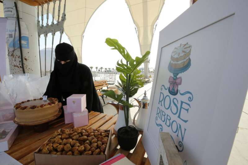 Ghada Al-Salman, 33, sets up her Rose Ribbon Bakery stall at Unaizah Season for Dates, at Unaizah city in Al-Qassim province, Saudi Arabia August 10, 2021. REUTERS-Ahmed Yosri