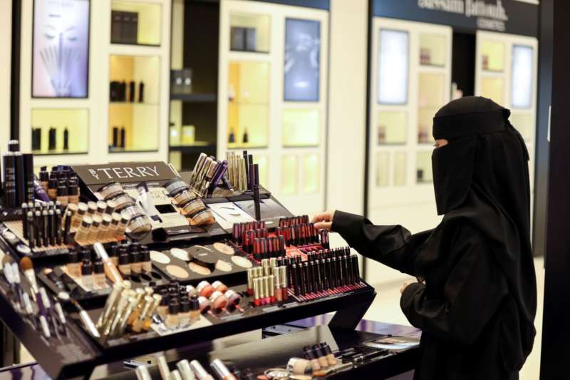 A Saudi woman buys makeup from a cosmetic shop in Centria Mall in Riyadh, Saudi Arabia, October 22, 2021. REUTERS-Ahmed Yosri